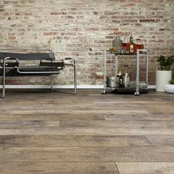 Natural Vintage wood flooring in a room with a brick wall