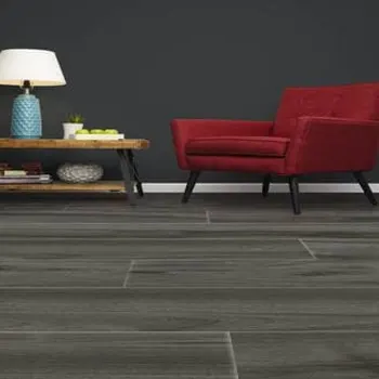 Dynamic II Floors in a dark seating area with a red armchair