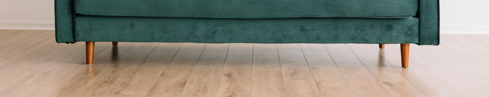 Durable Vinyl floor with a green velvet sofa