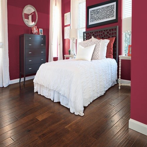 Hardwood Flooring in a bedroom with red walls