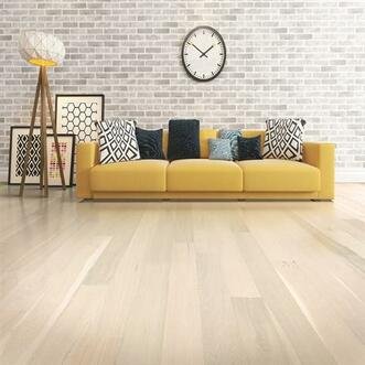 Vermont Light wood flooring in a living room with a yellow sofa