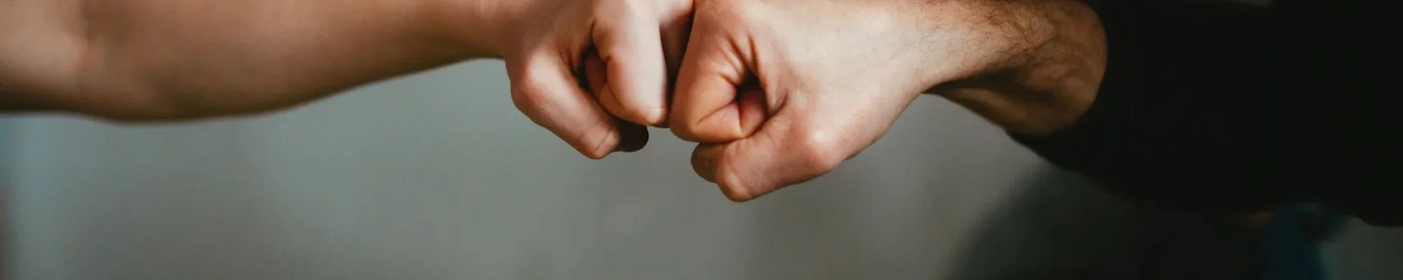 Two people fist bumping